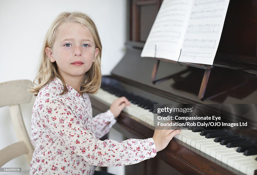 Girl (7-8) playing piano