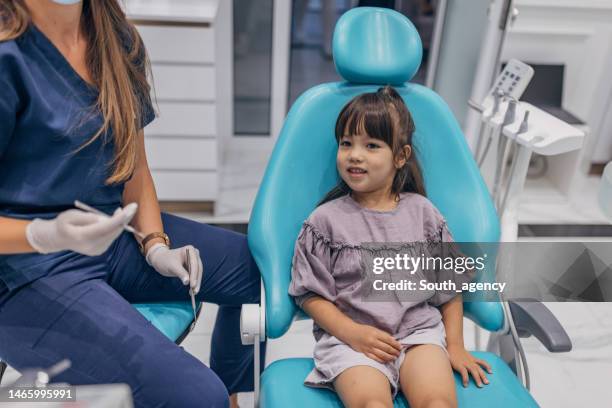 little girl at the dentist - cadeira de dentista imagens e fotografias de stock