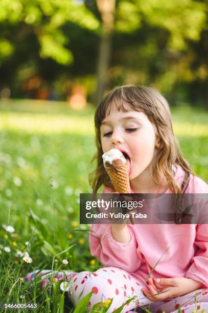 daughter enjoy ice cream. girl licking ice cream - girl eating messy ice cream cone stock pictures, royalty-free photos & images