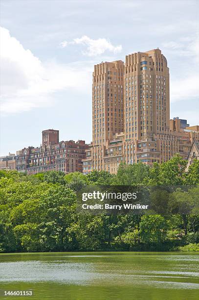 two towers of art deco building above lake in park - majestic apartments stock pictures, royalty-free photos & images