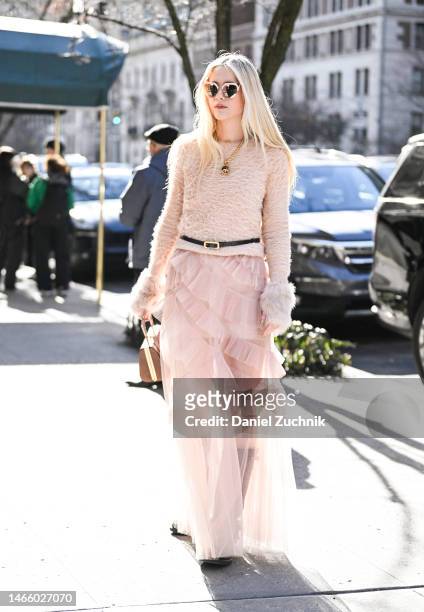 Guest is seen wearing a cream faux fur sweater, black belt, light pink sheer skirt outside the Coach show during New York Fashion Week F/W 2023 on...