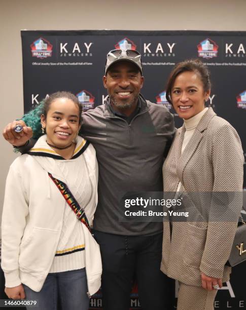 Ronde Barber, his wife Claudia Barber and daughter Justyce Barber pose for a photo with the hall of fame ring during the Kay Jewelers Ring of...