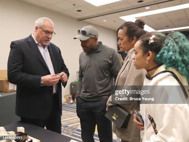 Ronde Barber and his family listen as a Kay Jeweler official explains the design of the hall of fame ring during the Kay Jewelers Ring of Excellence...