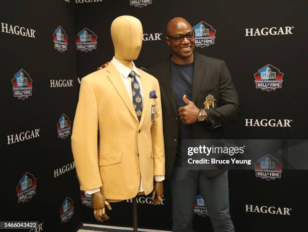 DeMarcus Ware poses for a photo next to the gold jacket during the Haggar Gold Jacket Fitting at the Pro Football Hall of Fame Sizing Saturday Event...