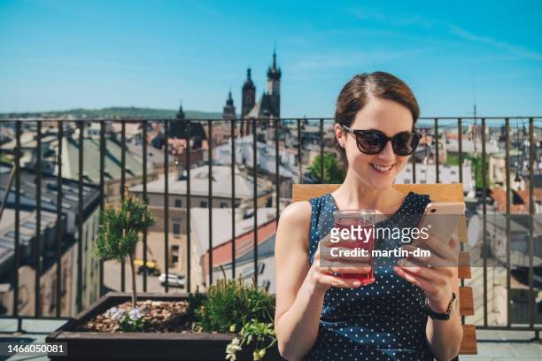 woman drinking juice at the terrace of hotel restaurant - expatriate stock pictures, royalty-free photos & images