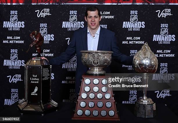 Evgeni Malkin of the Pittsburgh Penguins poses after winning the Ted Lindsay Award, the Art Ross Trophy and the Hart Trophy during the 2012 NHL...