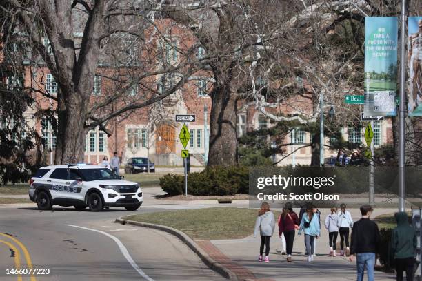 Police car blocks off a street on the campus Michigan State University on February 14, 2023 in East Lansing, Michigan. A gunman opened fire at two...