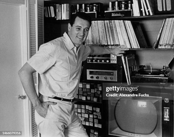 Actor Rock Hudson in front of TV at his house in 1963, Los Angeles, California.