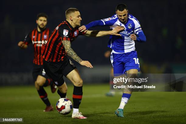 Aaron Collins of Bristol Rovers is held back by Luke Woolfenden of Ipswich Town during the Sky Bet League One between Bristol Rovers and Ipswich Town...