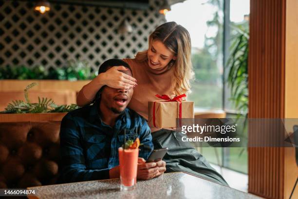 woman surprising man on valentines day. - happy valentines day stock pictures, royalty-free photos & images