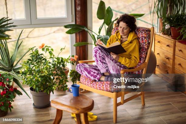 beautiful woman enjoying on glass terrace at home - indulgence stock pictures, royalty-free photos & images