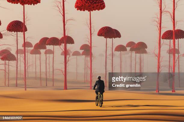 businessman cycling in strange surreal landscape - surreal landscape stockfoto's en -beelden