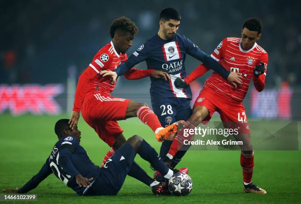 Carlos Soler of Paris Saint-Germain is challenged by Kingsley Coman and Jamal Musiala of FC Bayern Munich during the UEFA Champions League round of...