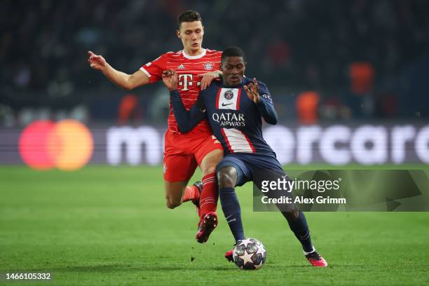 Nuno Mendes of Paris Saint-Germain is challenged by Benjamin Pavard of FC Bayern Munich during the UEFA Champions League round of 16 leg one match...