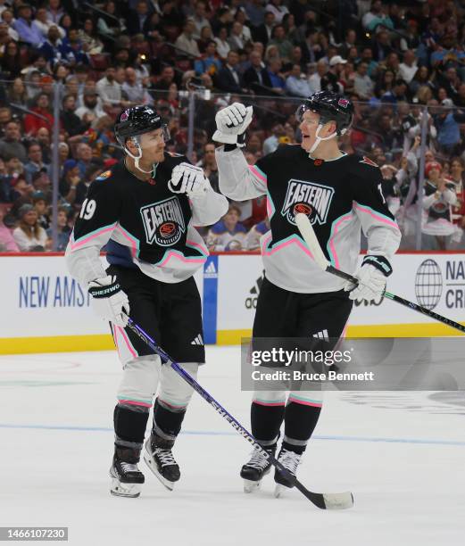 Brady Tkachuk of the Ottawa Senators congratulates his brother Matthew Tkachuk of the Florida Panthers on his goal during the 2023 NHL All-Star Game...