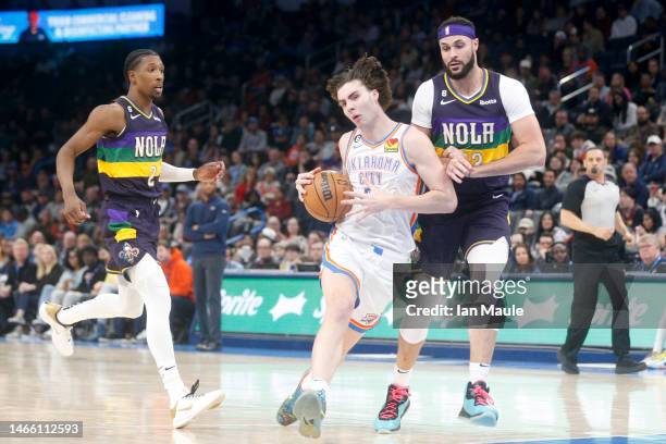 Josh Giddey of the Oklahoma City Thunder drives past Larry Nance Jr. #22 of the New Orleans Pelicans during the third quarter at Paycom Center on...