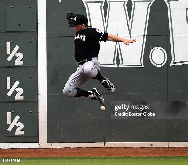 Miami Marlins left fielder Logan Morrison can't make a play on a bases clearing double by Boston Red Sox right fielder Cody Ross in the third inning...