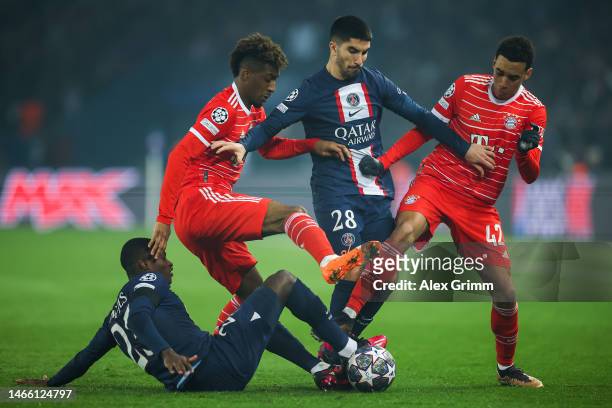 Carlos Soler of Paris Saint-Germain is challenged by Kingsley Coman and Jamal Musiala of FC Bayern Munich during the UEFA Champions League round of...