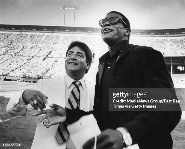 San Francisco 49ers owner Eddie DeBartolo Jr. And Ahmad Rashad are photographed at a pre-season game against the Denver Broncos at Candlestick Park...