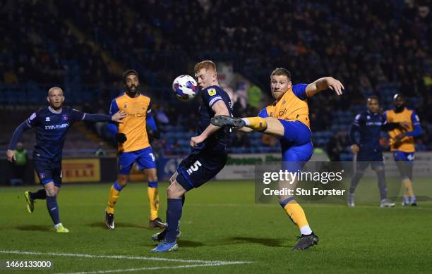 Carlisle player Morgan Feeney is challenged by Mansfield player Alfie Kilgour during the Sky Bet League Two between Carlisle United and Mansfield...
