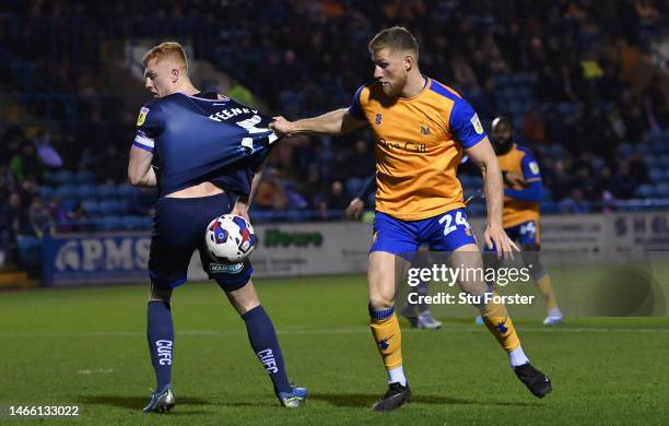 Carlisle player Morgan Feeney is challenged by Mansfield player Alfie Kilgour during the Sky Bet League Two between Carlisle United and Mansfield...