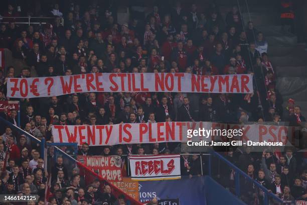 Bayern Munich supporters lift banners in protest of ticket prices for away supporters during the UEFA Champions League round of 16 leg one match...