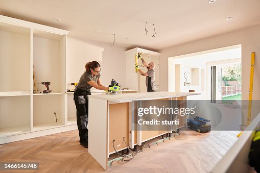 Kitchen fitters installing some cabinets Kitchen fitters installing some cabinets