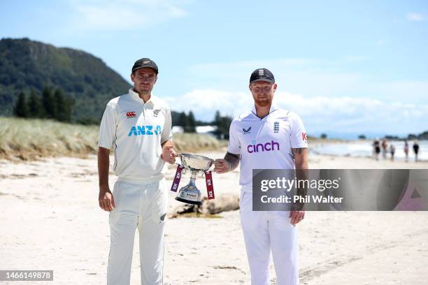 New Zealand Blackcaps captain Tim Southee and England captain Ben Stokes pose with the trophy on the Mount Maunganui beach during a media opportunity...