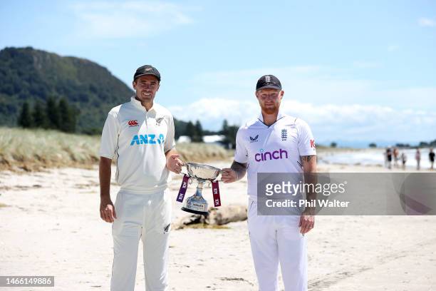 New Zealand Blackcaps captain Tim Southee and England captain Ben Stokes pose with the trophy on the Mount Maunganui beach during a media opportunity...
