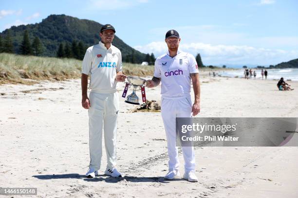 New Zealand Blackcaps captain Tim Southee and England captain Ben Stokes pose with the trophy on the Mount Maunganui beach during a media opportunity...