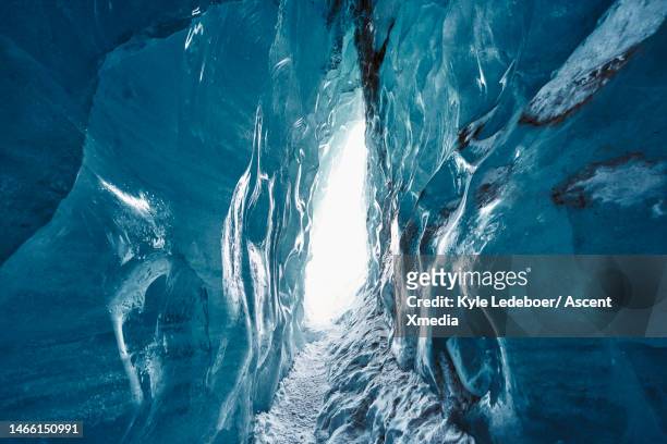 view down glacial crack to opening - crevasse stock pictures, royalty-free photos & images