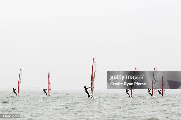 Competitors race during the Windsurfing Women's T293 race on Day 5 of the 3rd Asian Beach Games Haiyang 2012 at XXXX on June 21, 2012 in Haiyang,...