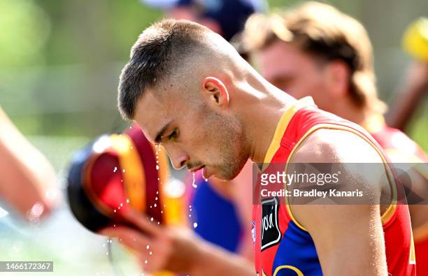 Darcy Wilmot attempts to cool down as he takes a drinks break during a Brisbane Lions AFL training session at Brighton Homes Arena on February 15,...