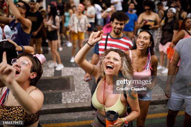 group of friends celebrating carnival party - parade crowd stock pictures, royalty-free photos & images