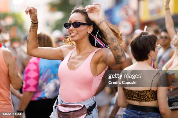 beautiful woman celebrating brazilian carnival on the street - carnaval stock pictures, royalty-free photos & images