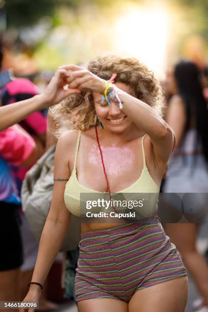 women enjoying a carnival street party - carnaval woman stock pictures, royalty-free photos & images