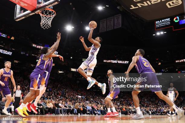 De'Aaron Fox of the Sacramento Kings puts up a shot over Saben Lee of the Phoenix Suns during the first half of the NBA game at Footprint Center on...