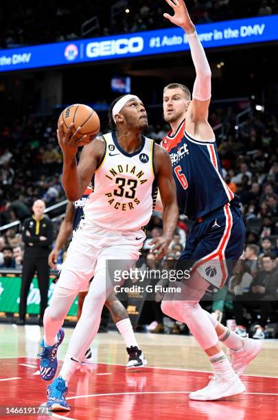 Myles Turner of the Indiana Pacers drives to the basket against Kristaps Porzingis of the Washington Wizards at Capital One Arena on February 11,...