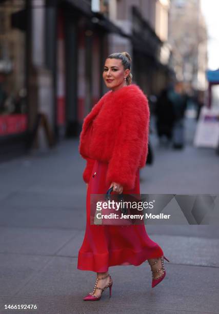 Olga Ferrara wearing Milly red rose fake fur coat, Milly long knit rose red dress, Valentino rose heels, Lady Dior matching leather bag, Pharaoun...