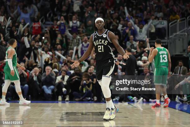 Jrue Holiday of the Milwaukee Bucks reacts to a three point shot during the second half of a game against the Boston Celtics at Fiserv Forum on...