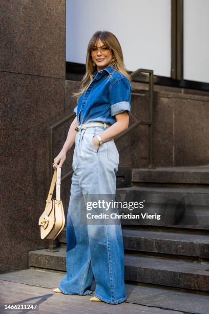 Julianne Hough wears denim shirt, jeans, beige bag outside Brandon Maxwell during New York Fashion Week on February 14, 2023 in New York City.