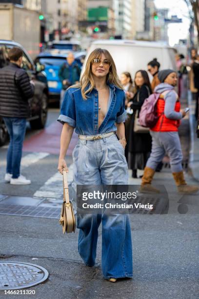 Julianne Hough wears denim shirt, jeans, beige bag outside Brandon Maxwell during New York Fashion Week on February 14, 2023 in New York City.