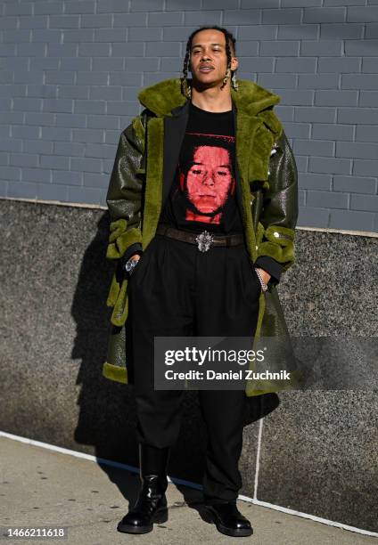 Guest is seen wearing a green faux fur coat, black tee and black pants with black boots outside the Pamella Roland show during New York Fashion Week...