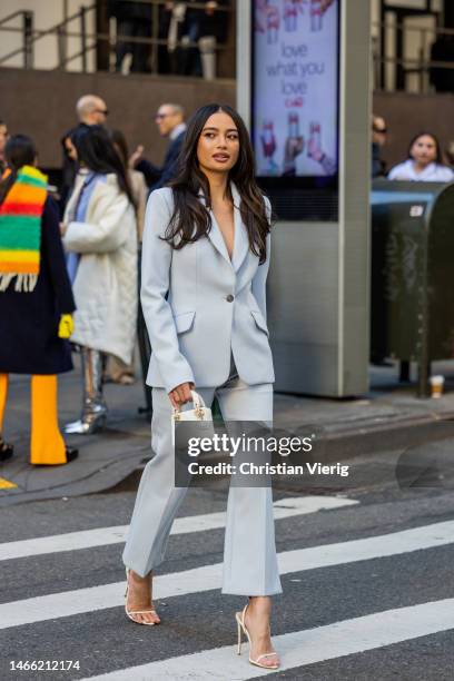 Model Kelsey Merritt wears turquoise suit, white mini Dior bag, heels outside Brandon Maxwell during New York Fashion Week on February 14, 2023 in...