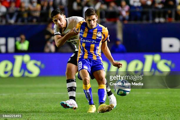 Salvador Reyes of America fights for the ball with Juan Sanabria of San Luis during the 7th round match between Atletico San Luis and America as part...