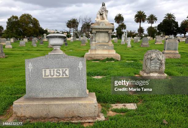 Gravestones stand above green grass at Evergreen Cemetery, which lacks recycled water and is the city's oldest nondenominational cemetery, on...