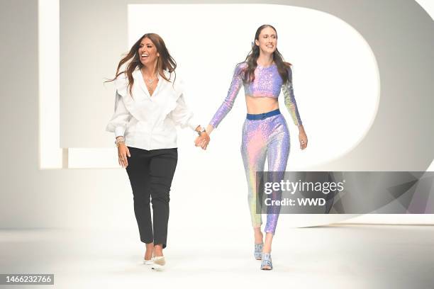 Laura Biagiotti and Anna Cleveland on the catwalk