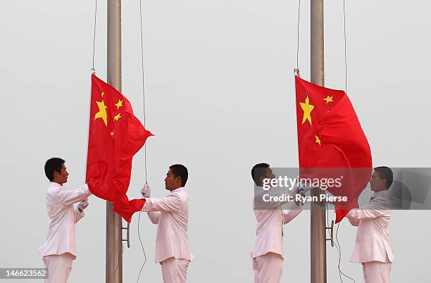 Chinese flags are raised at the medal ceremony after the Windsurfing T293 race on Day 5 of the 3rd Asian Beach Games Haiyang 2012 at on June 21, 2012...