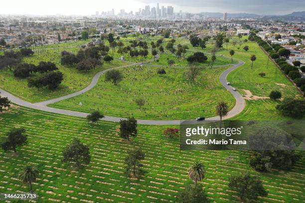 In an aerial view, gravestones stand above green grass at Evergreen Cemetery, which lacks recycled water and is the city's oldest nondenominational...