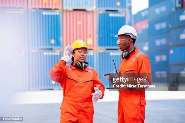 digitalize processes, improve operations, and decrease admin costs in cargo container service. teams of african american logistics engineers having a discussion at a cargo container yard about operations improvement in cargo container handling. - global opportunity stock pictures, royalty-free photos & images